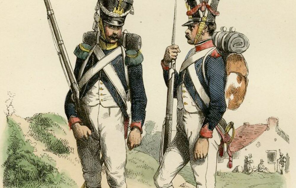 Two French soldiers in blue jackets stand and converse