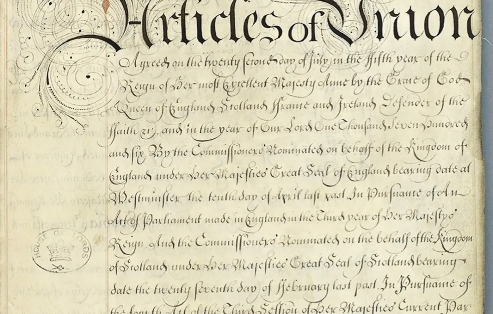 A single yellowing document with the words "Articles of Union" written in elaborate handwriting at the top