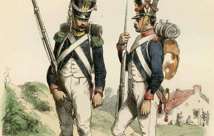 Two French soldiers in blue jackets stand and converse