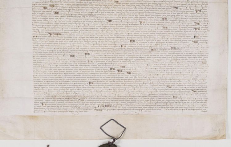 A 15th century document outlining the Treaty of Troyes with a blackened wax seal at the bottom