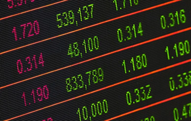 A black screen with red and green numbers separated by orange bars denoting rising and falling stock values.