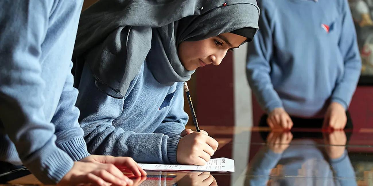 Three schoolchildren engaged in an assignment