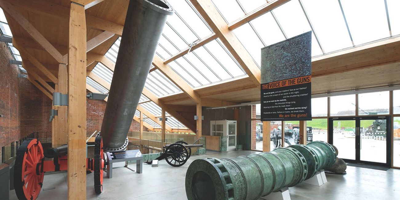 2 large gun barrels on display inside of Fort Nelson
