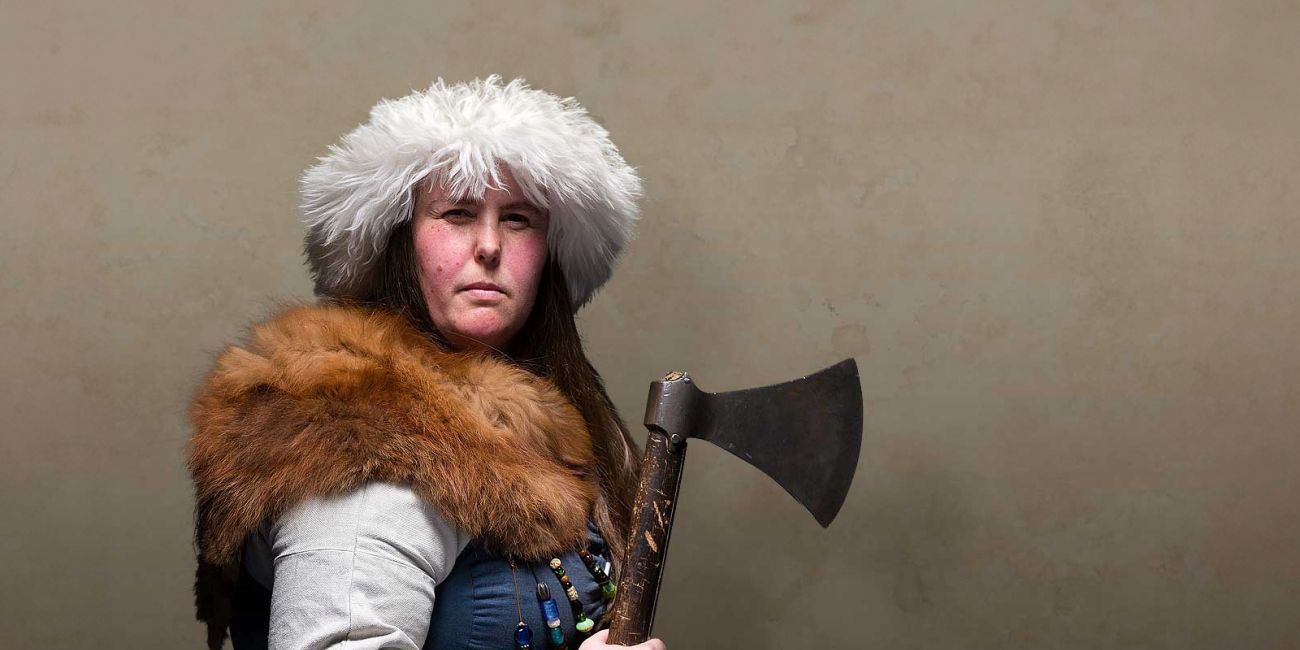 A Viking warrior woman brandishes an axe menacingly