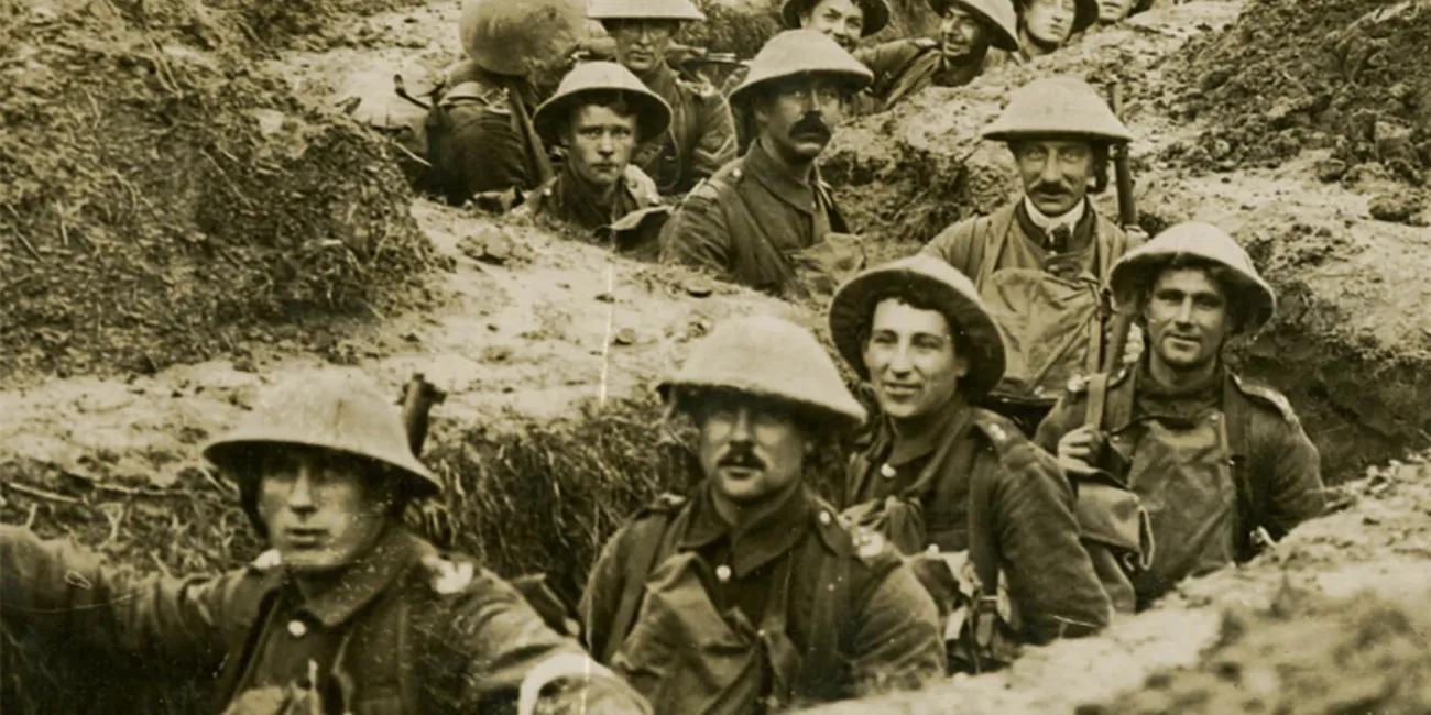 WWI soldiers stood in line in a trench
