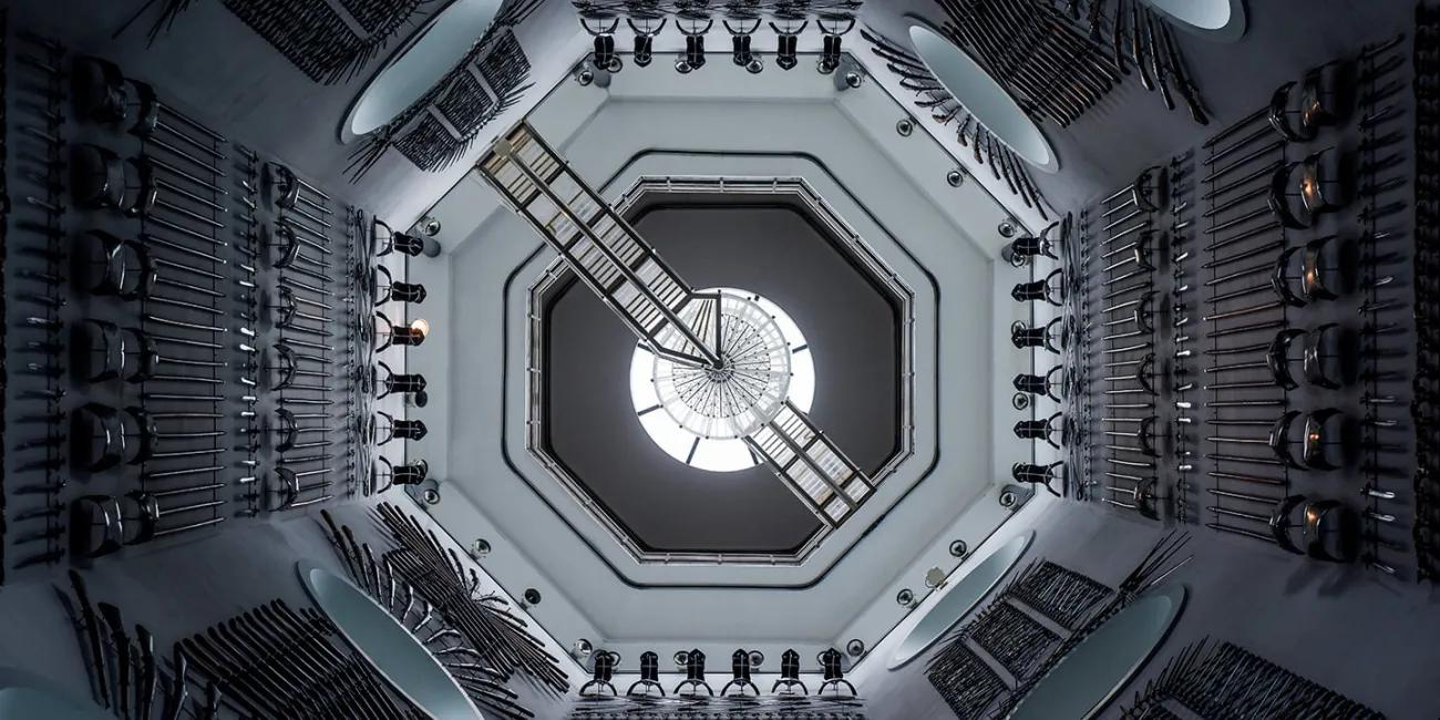 looking up into a tall tower of arms and armour