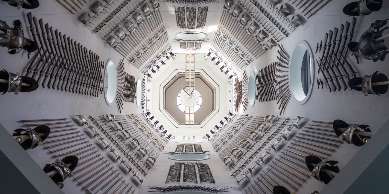 looking up at the Hall of Steel interior with every wall covered in magnificent arms and armour displays