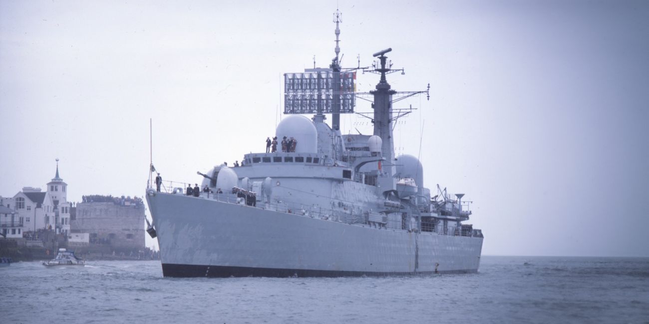 Small craft welcome the Type 42 Destroyer as the ship returns to Portsmouth harbour