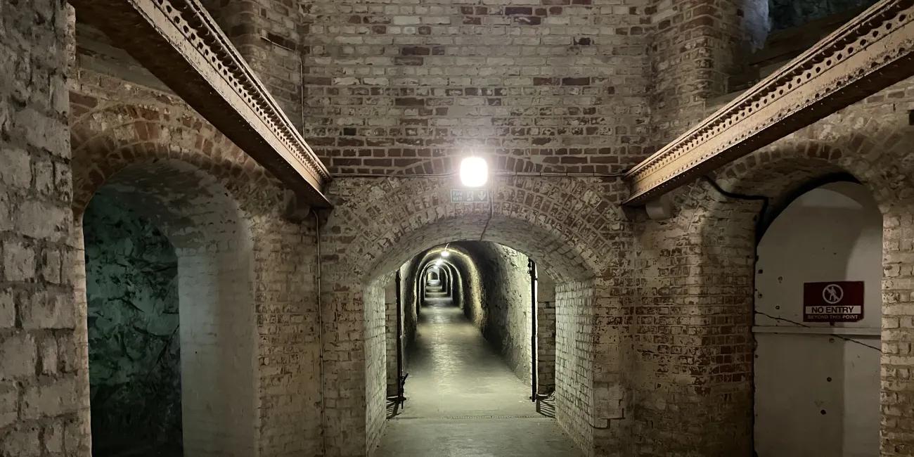 archway entrance to a long brickwork tunnel