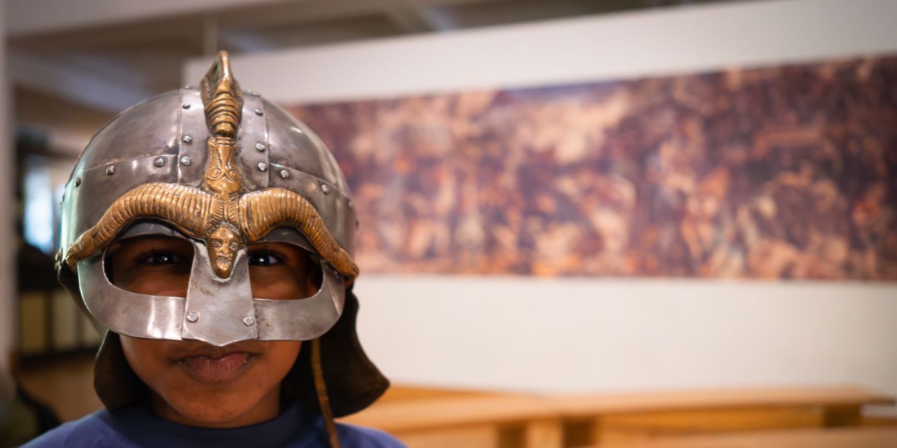 child stares intently through the visor of a helmet