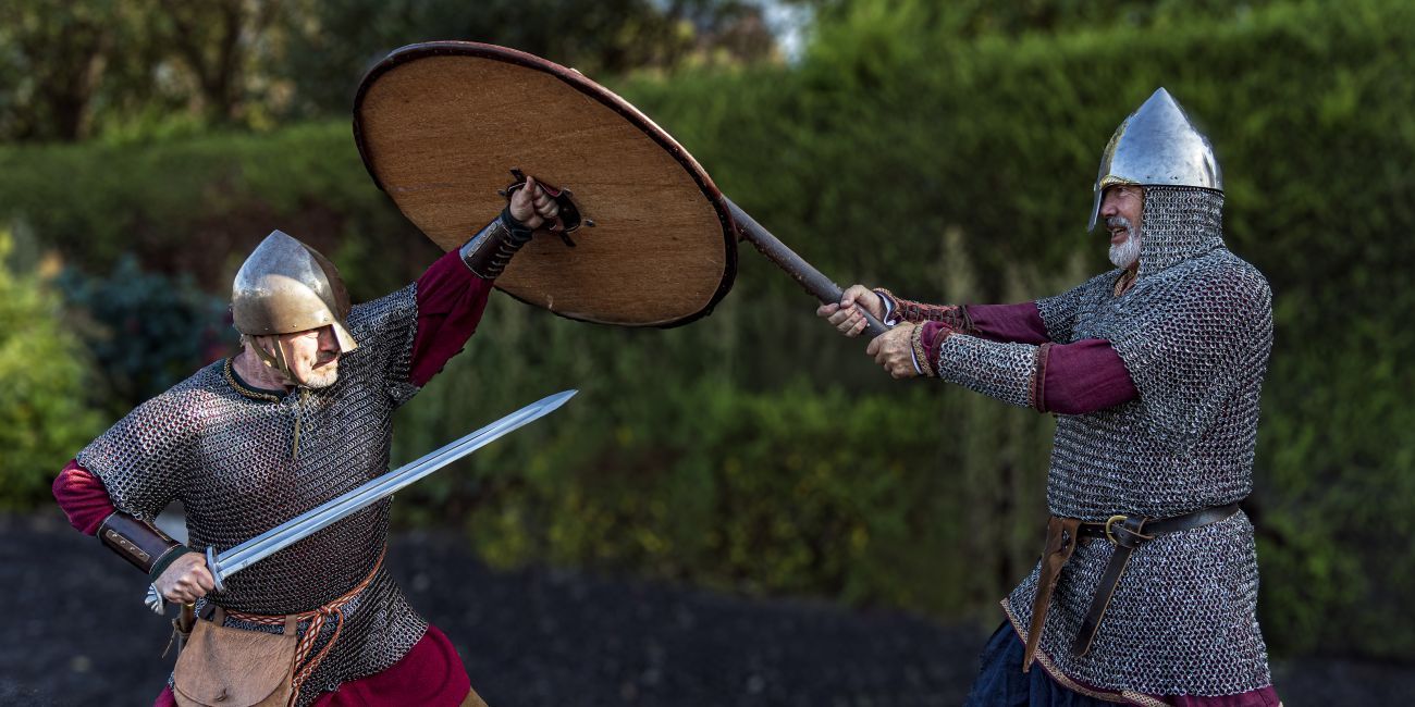 two Viking warriors battling with swords and shields