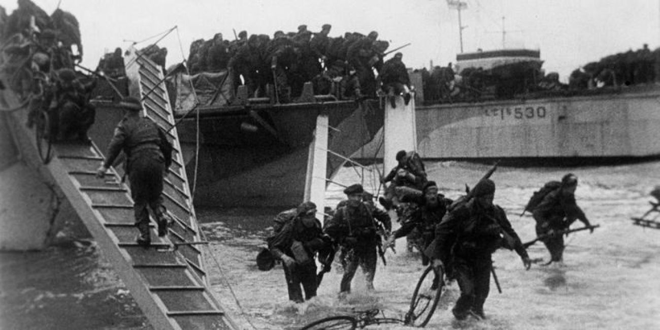 Original photo showing British Forces disembarking from landing craft on to Normandy beaches during the D-Day.