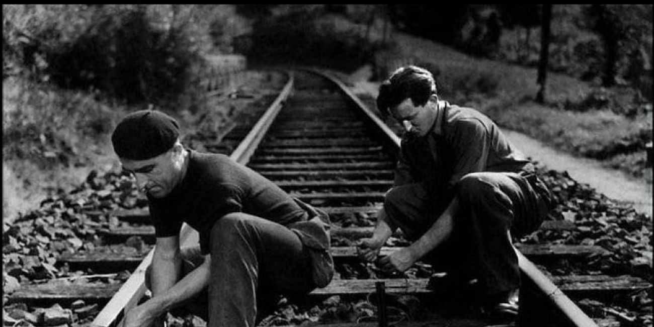 Two men planting explosives on a railway line
