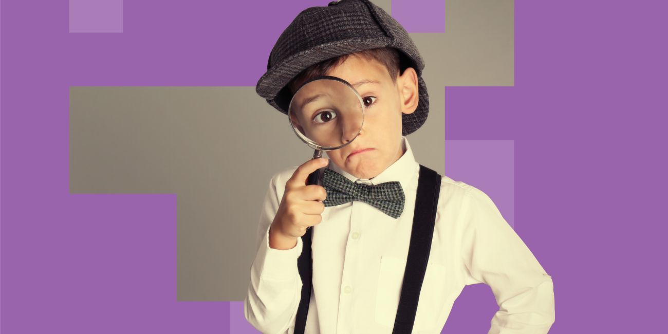 Young boy dressed in deerstalker hat with microscope.