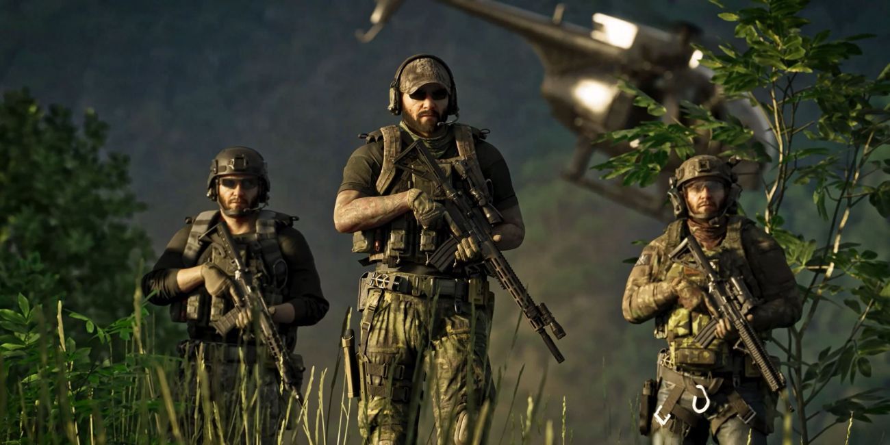 Three soldiers holding firearms with helicopter in the background.