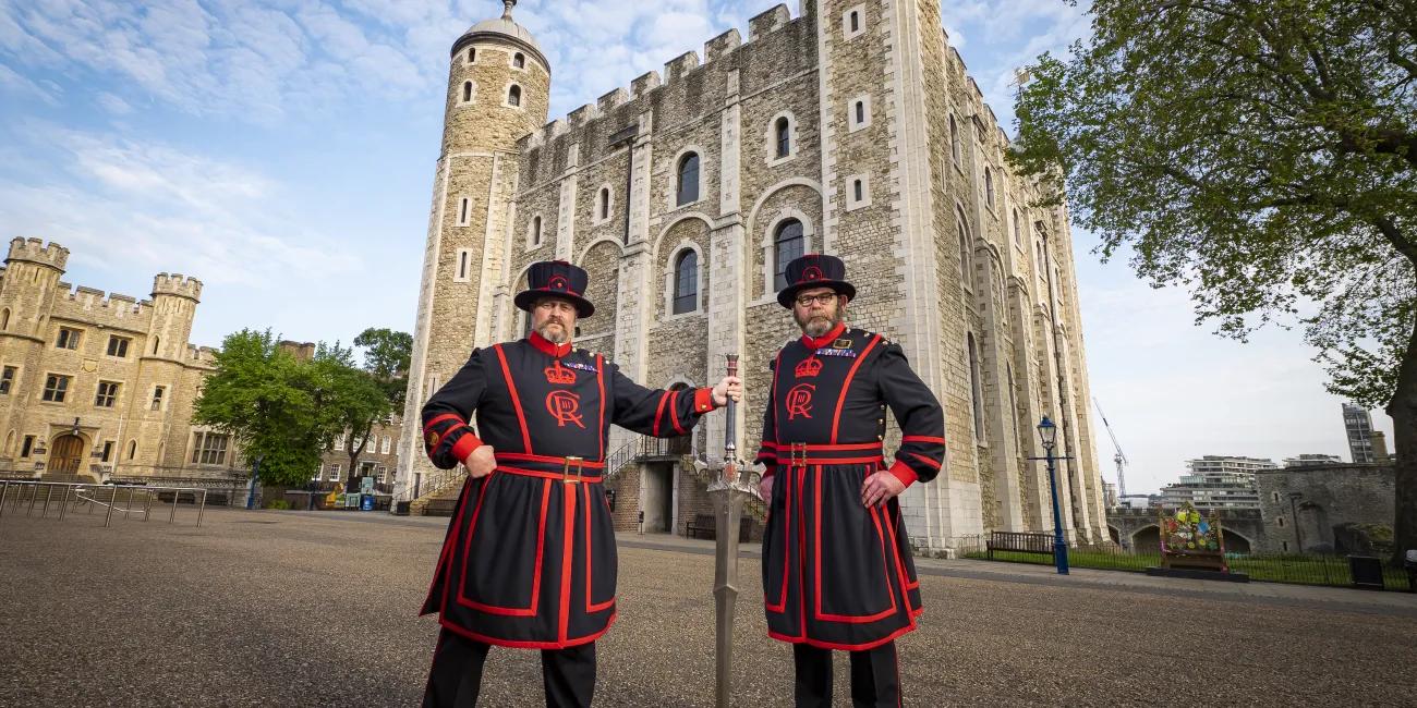 Two Yeoman Warder with the FINAL FANTASY XVI Invictus Sword in front of the white tower at the Tower of London