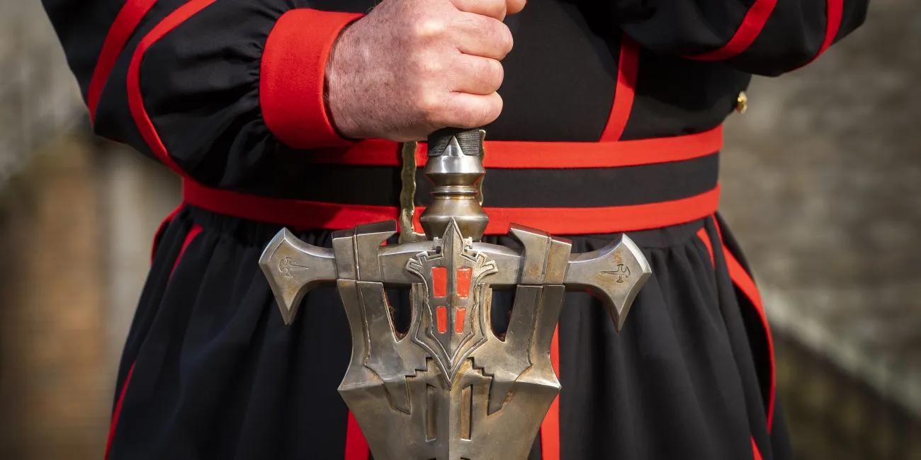 Yeoman Warder holding FINAL FANTASY XVI Invictus Sword hilt