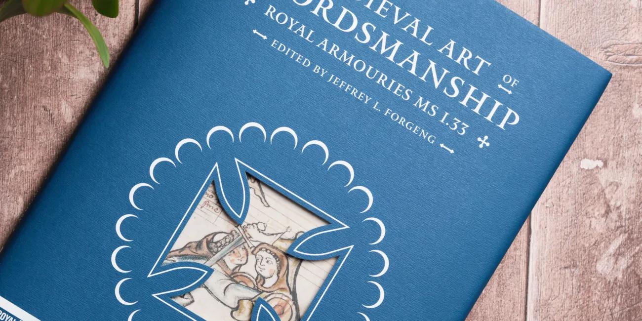 The Medieval art of swordsmanship book on wooden table