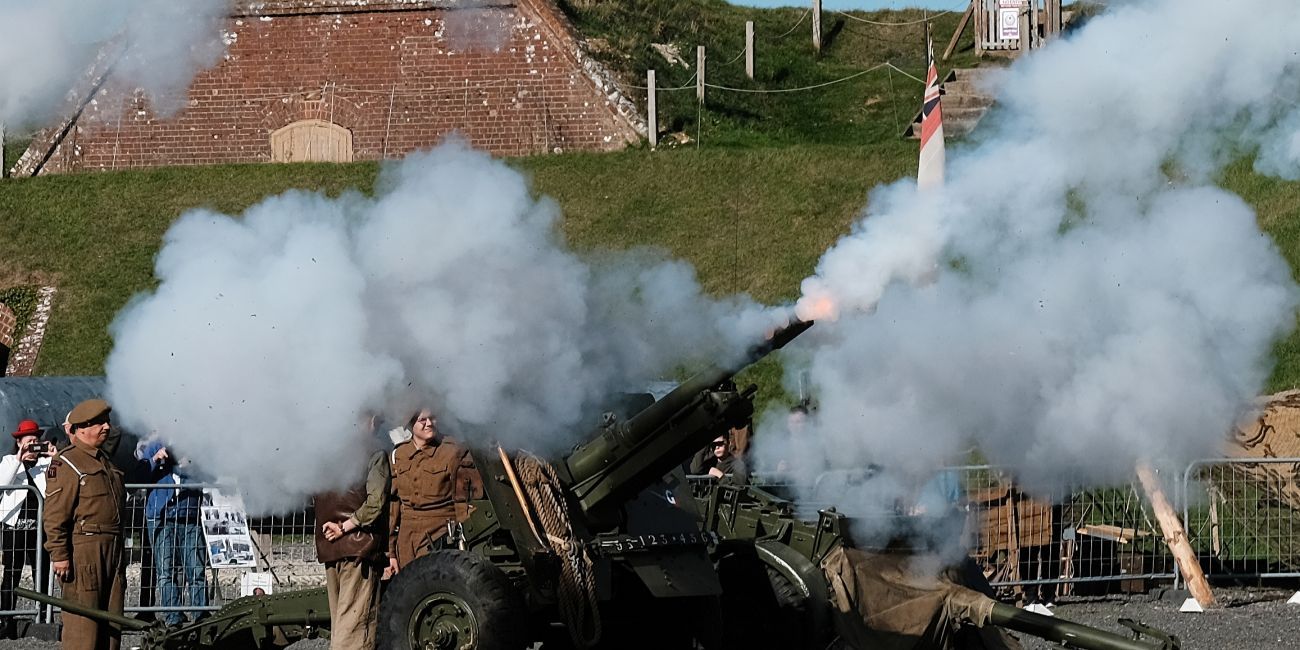 Second World War artillery firing, enveloped in smoke