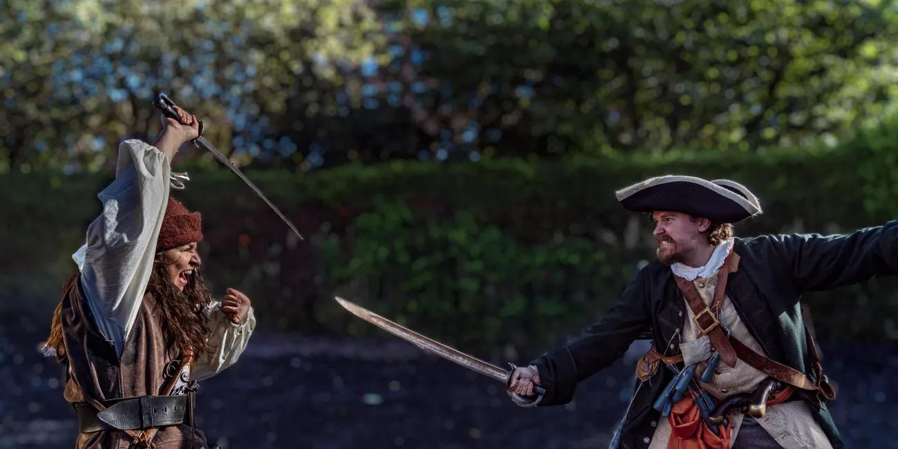 Two pirates duelling with swords.
