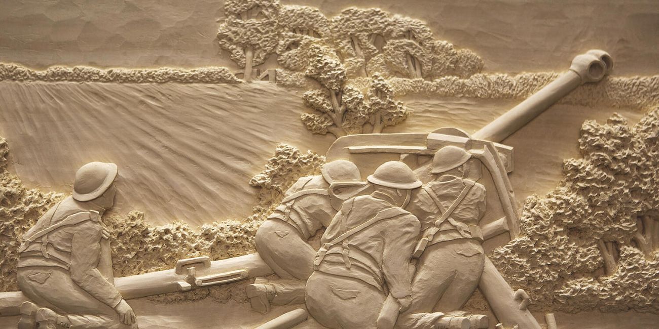 Wood carving of a Second World War 4-man artillery crew firing a Howitzer Field Gun