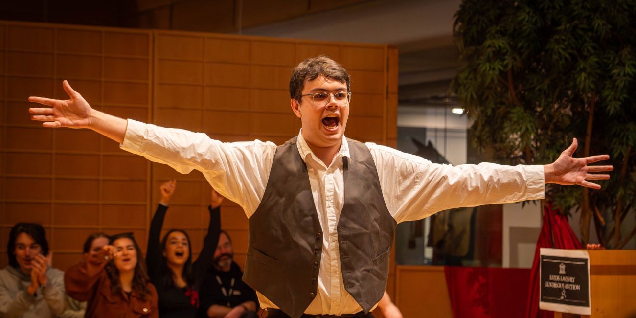 Actor with arms outstretched