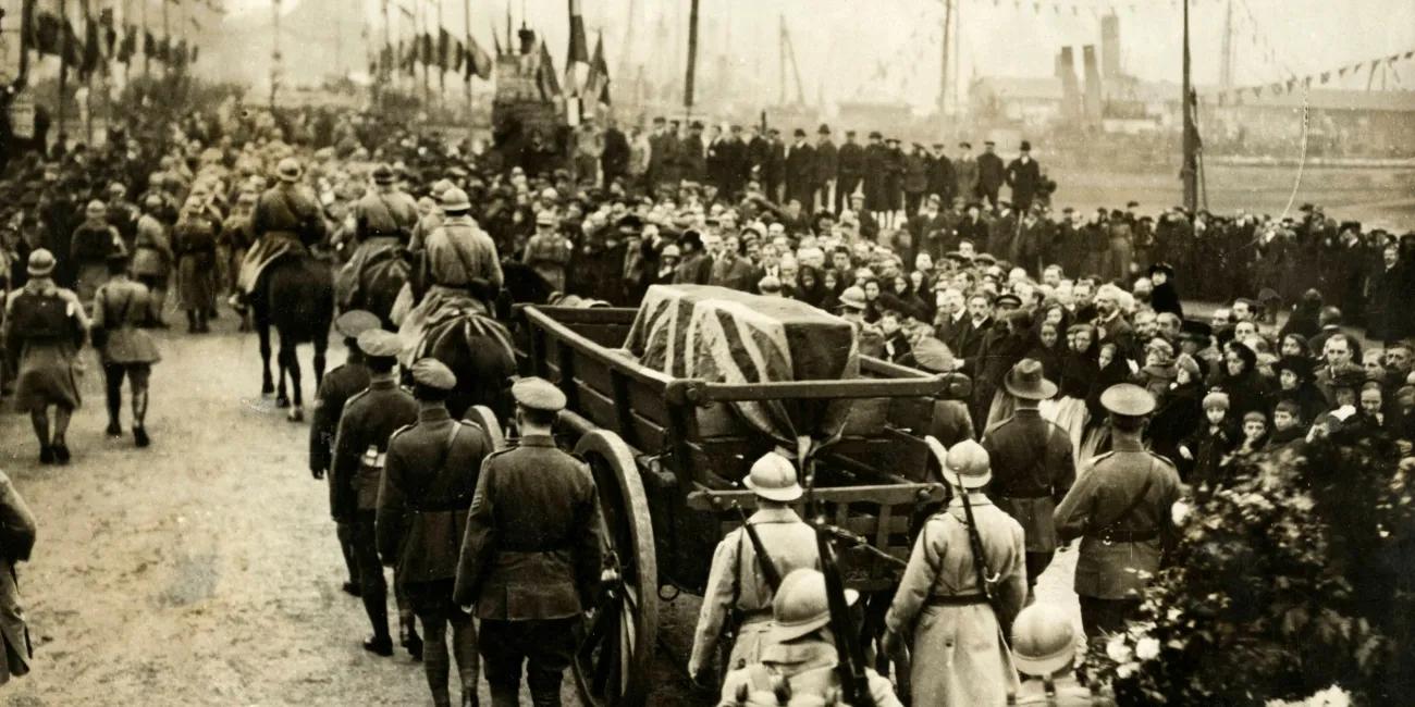 Photograph of coffin draped in Union Jack flag on a carriage