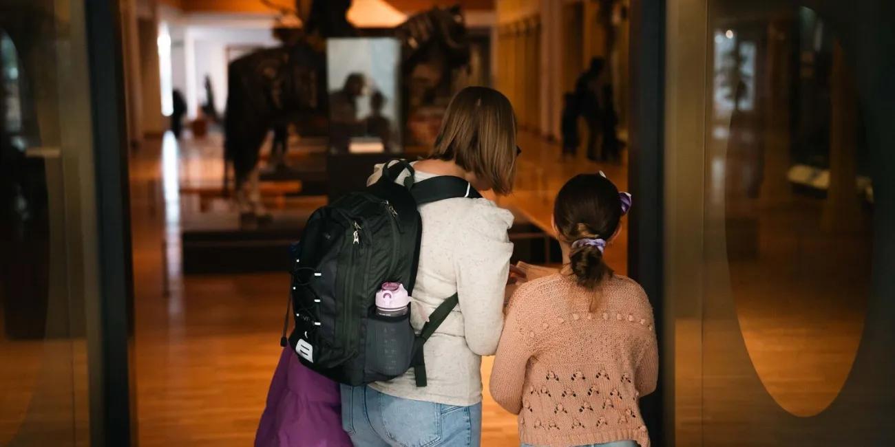 An adult and child entering the Asian and African Gallery.