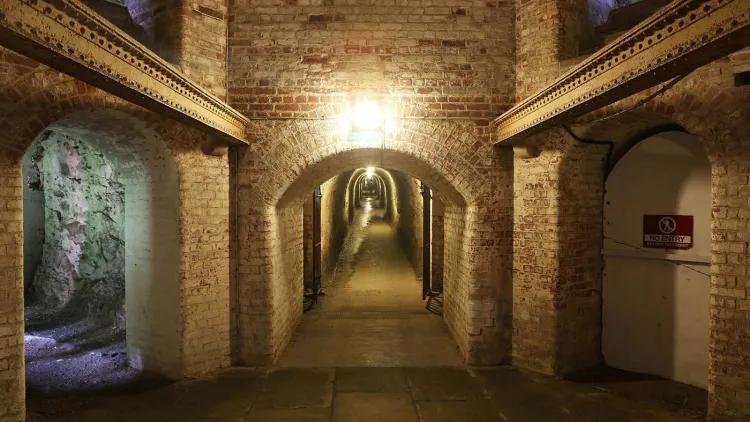 Arched entrance to a long brickwork tunnel