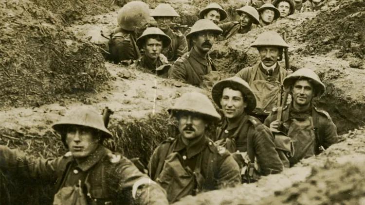 WWI soldiers stood in line in a trench
