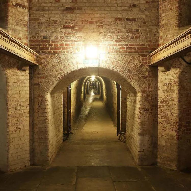 Arched entrance to a long brickwork tunnel