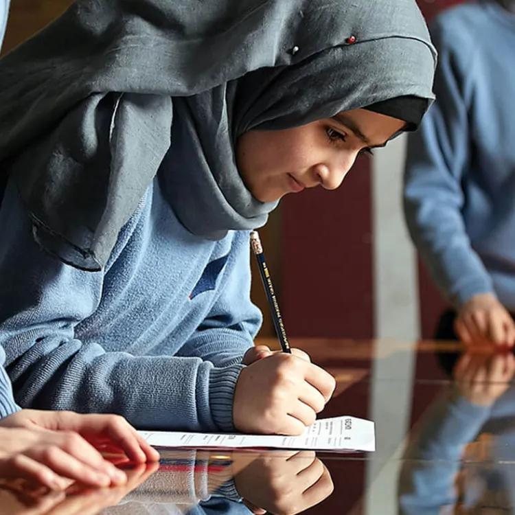 Three schoolchildren engaged in an assignment
