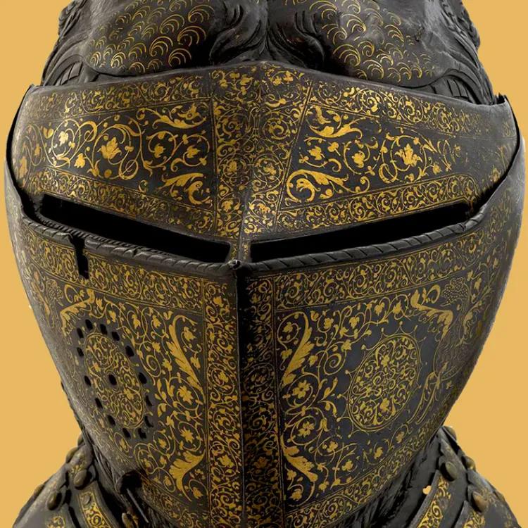 decorated knights helmet on a golden background