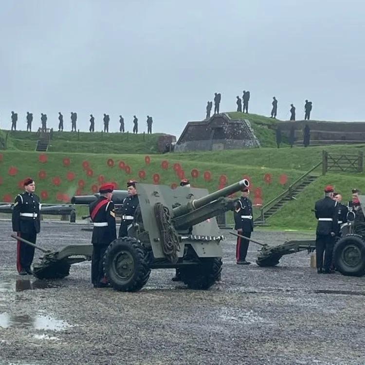 military personnel preparing to fire a gun mounted on a carriage