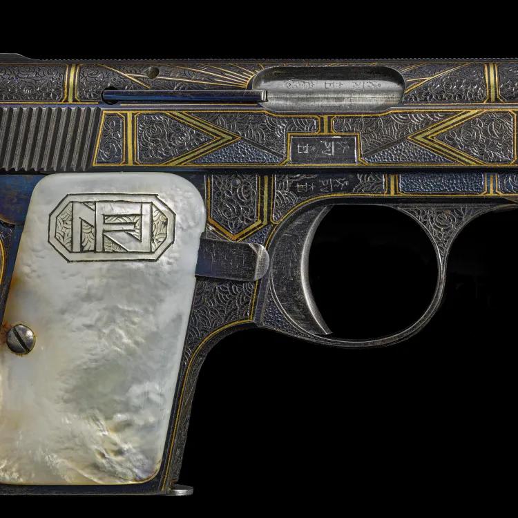 A blue, gold and yellow patterned pistol on a black background
