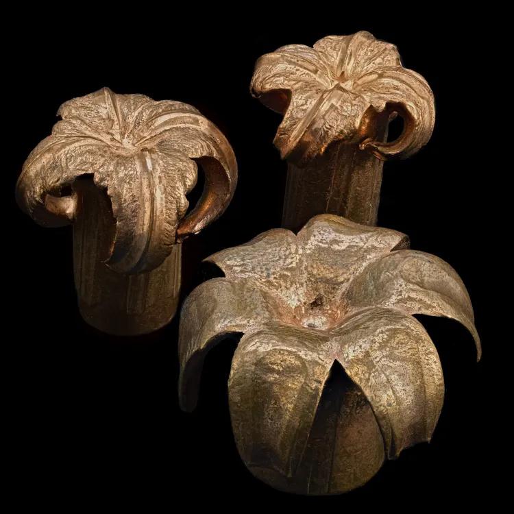 Three copper bullets which are expanded to look like flower petals 