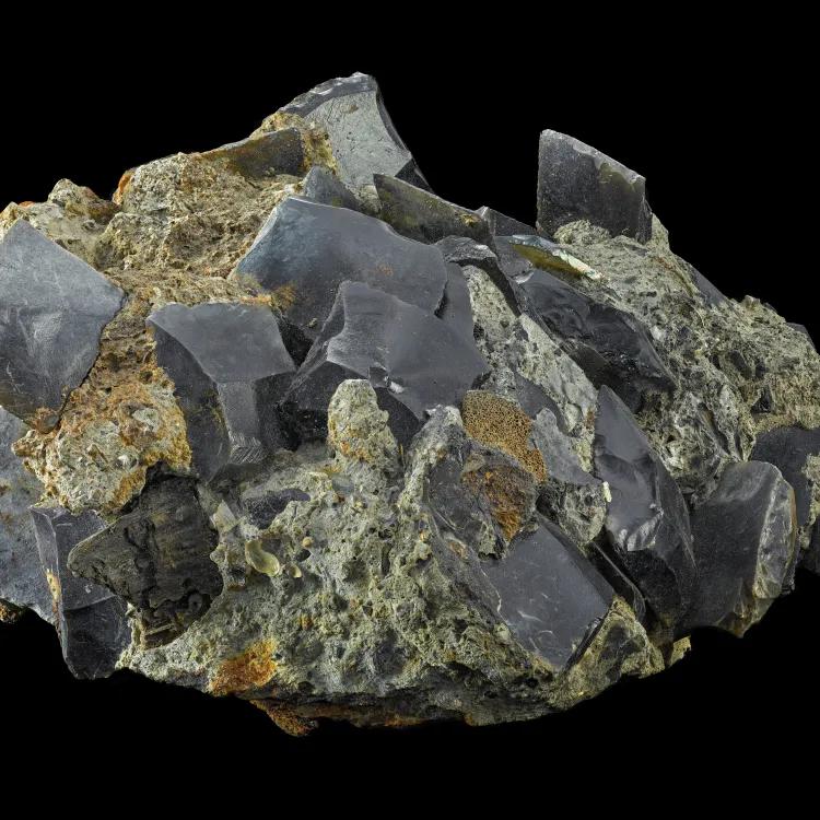 A lump of concrete gun flints against a black background