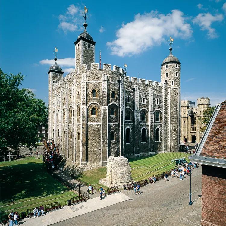 A square stone tower with taller narrow towers at each corner
