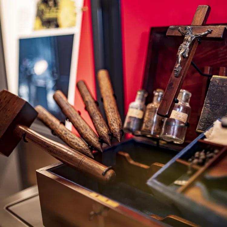 A sinister looking vampire killing kit containing a wooden mallet and four stakes, bottles of garlic, silver and holy water, a crucifix and bible