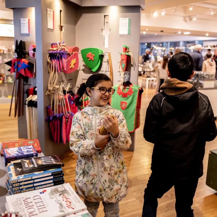 2 children looking at all of the interesting objects on display in the Leeds shop