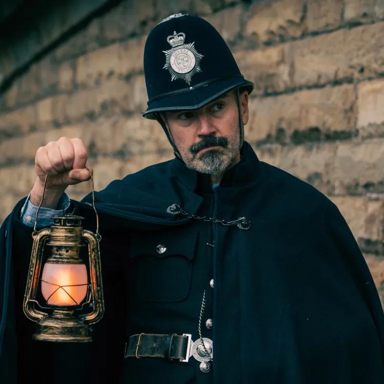 Actor in costume as Victorian police officer