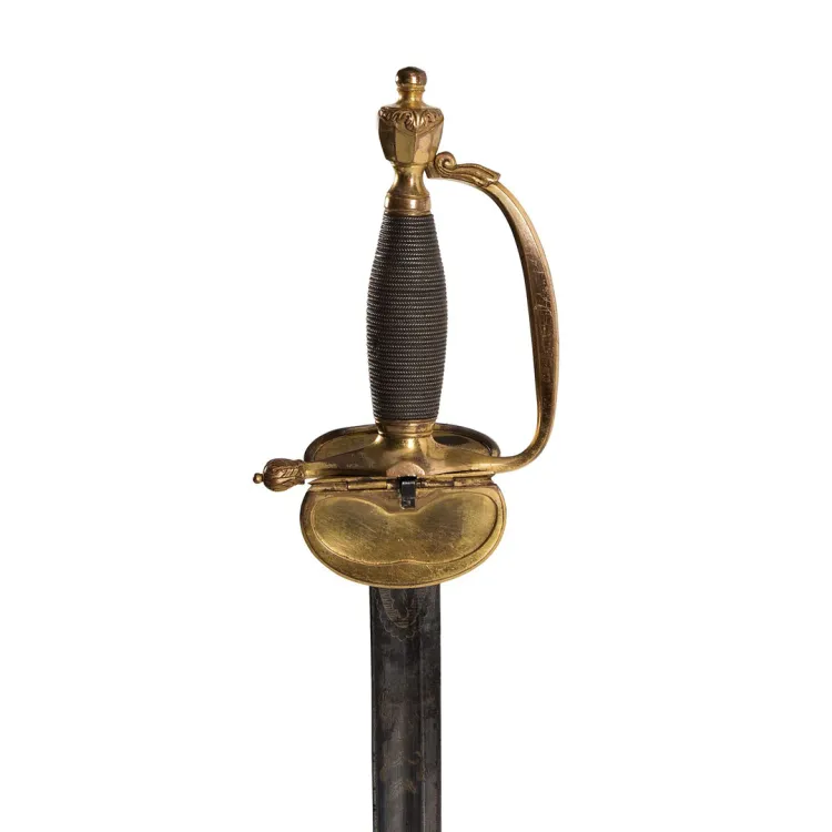 A thin tapering blade attached to brass gilt hilt, a broad, flat cross guard and single bar knuckle guard
