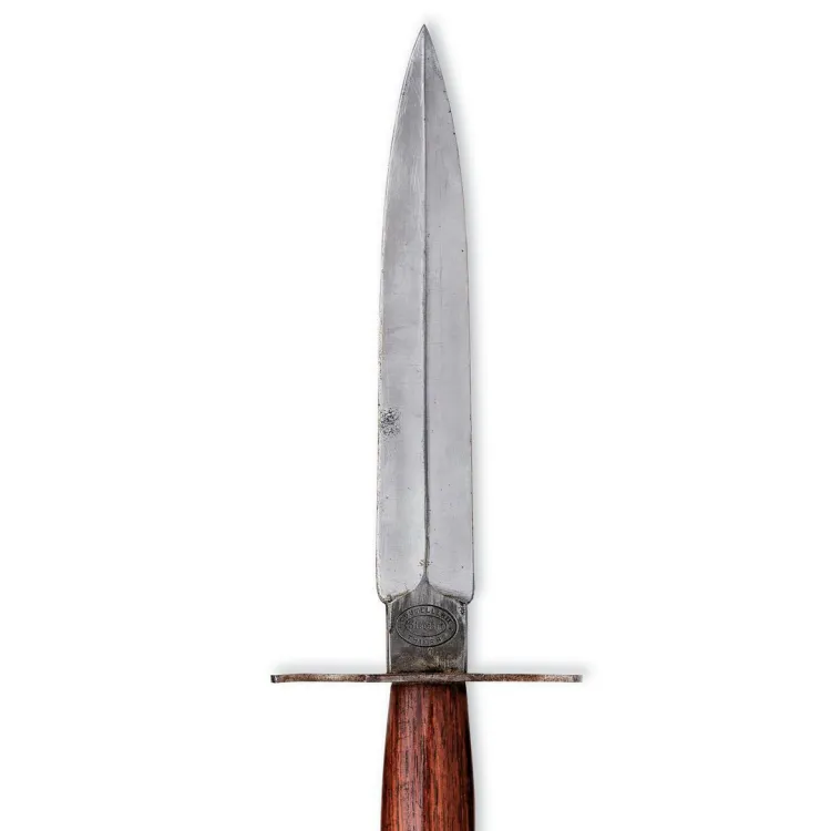 A leaf shaped knife blade with a simple cross guard and reddish wooden hilt