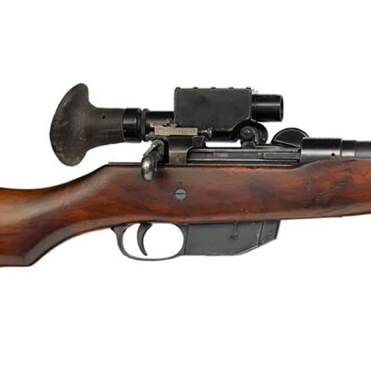 A brown rifle with metallic elements and a large eyepiece and scope attachment 
