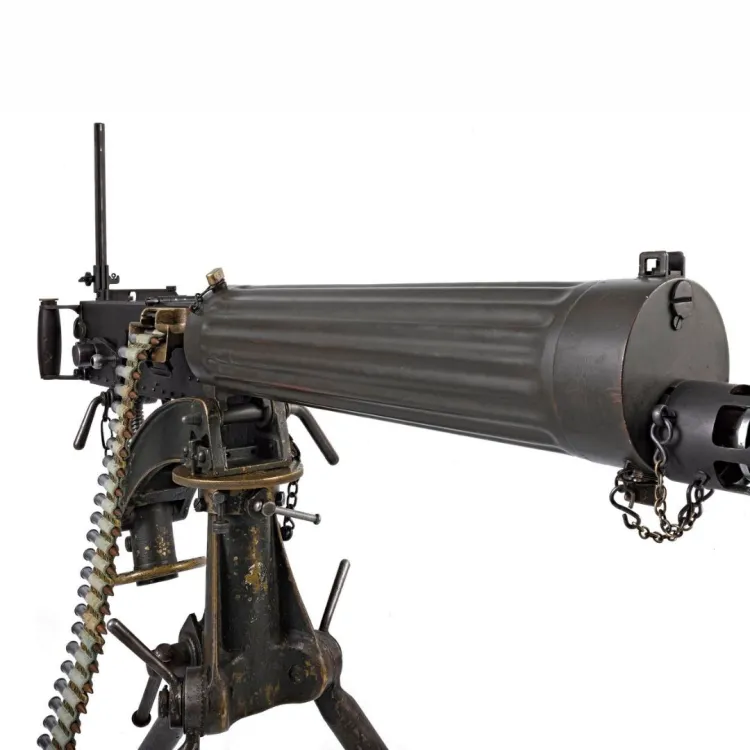 A long barrelled machine gun with fluted sleeve over the barrel and a belt of ammunition