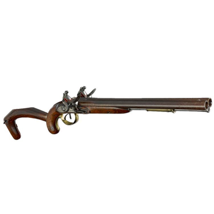 A double barrelled flintlock pistol with two separate flintlocks. Finished in wood, steel, and a brass trigger guard.