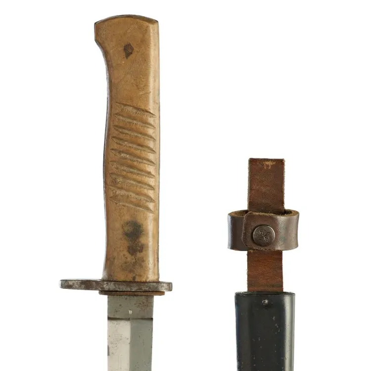 A steel, double edged blade with a light coloured wooden grip and a leather sheath