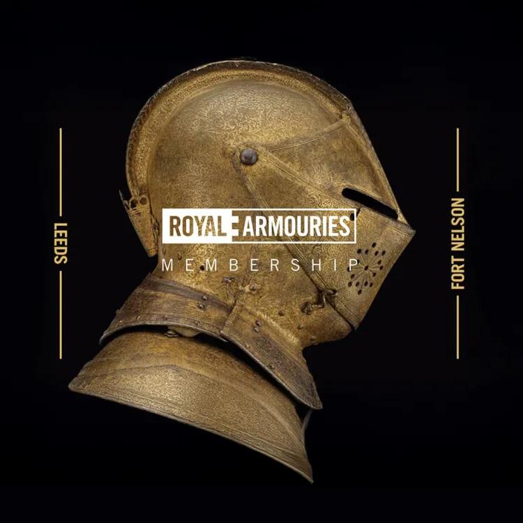 Gold coloured highly decorated armoured helmet with visor down on a black background