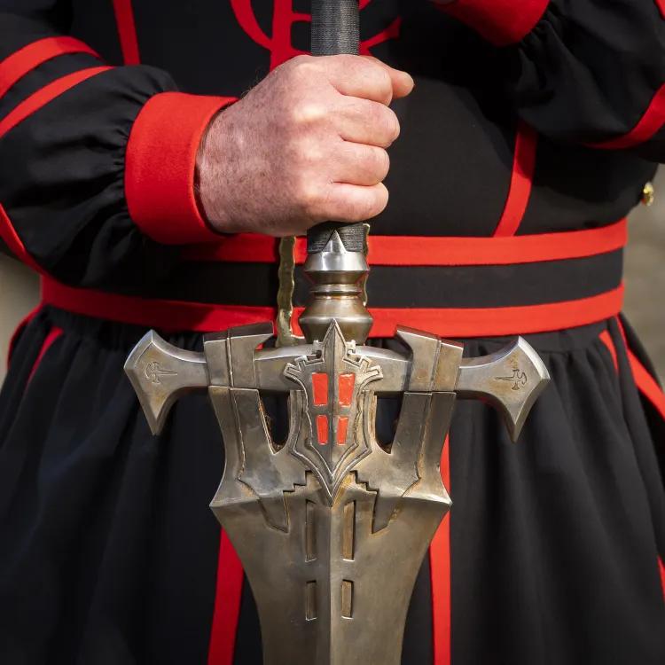 Yeoman Warder holding FINAL FANTASY XVI Invictus Sword hilt