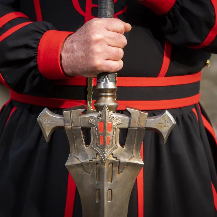 Yeoman Warder holding FINAL FANTASY XVI Invictus Sword hilt